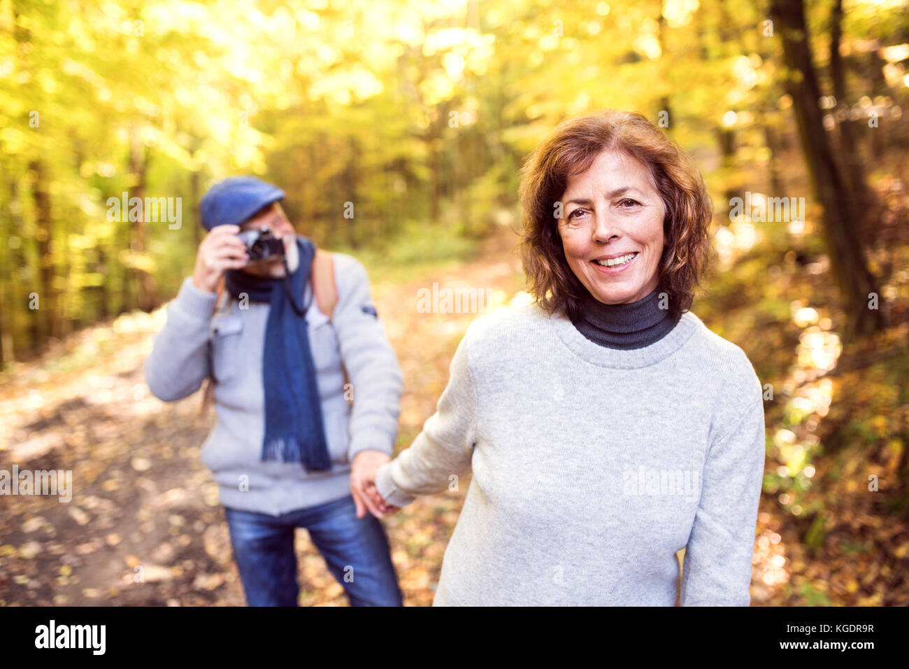 Senior couple on a walk in autumn forest Stock Photo - Alamy