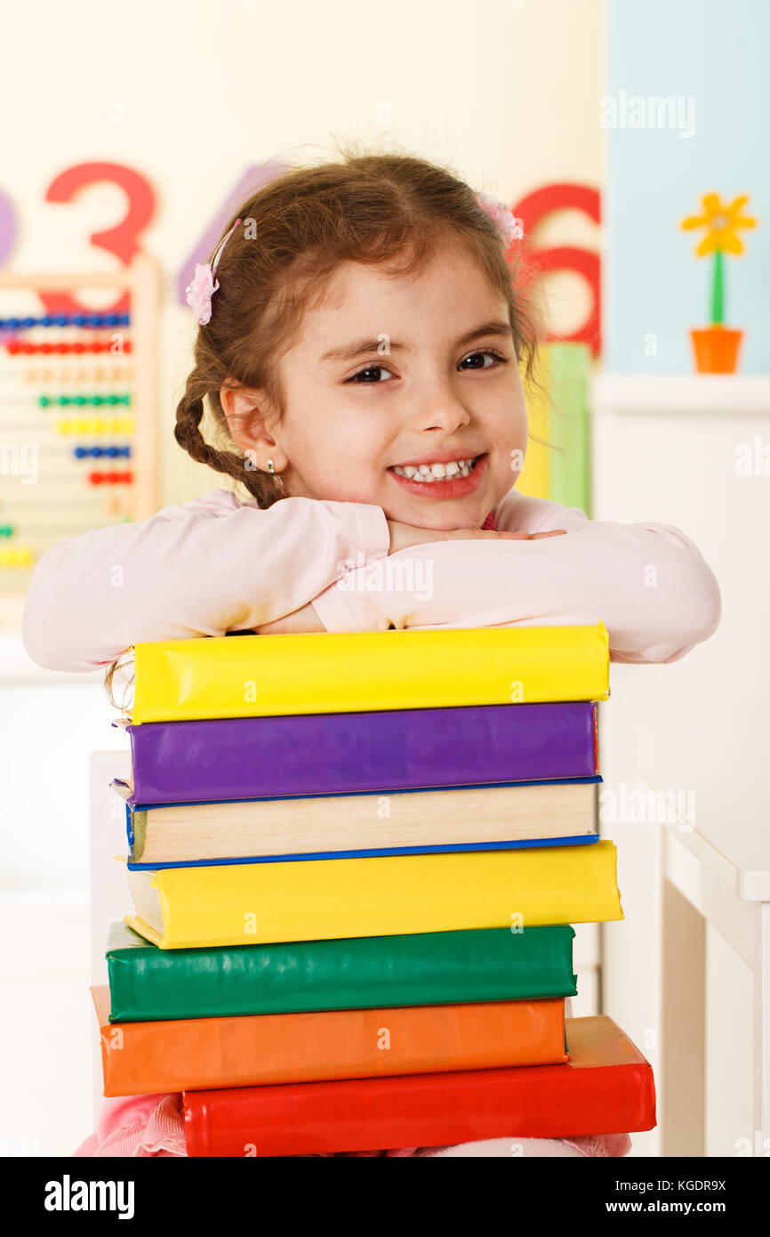Preschool girl with a books Stock Photo - Alamy