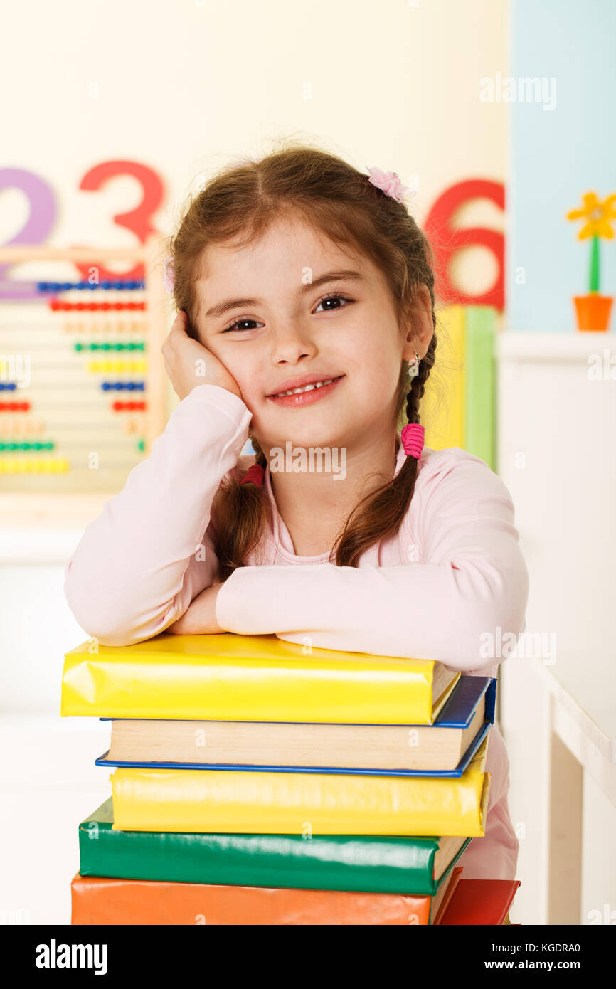 Preschool girl with a books Stock Photo