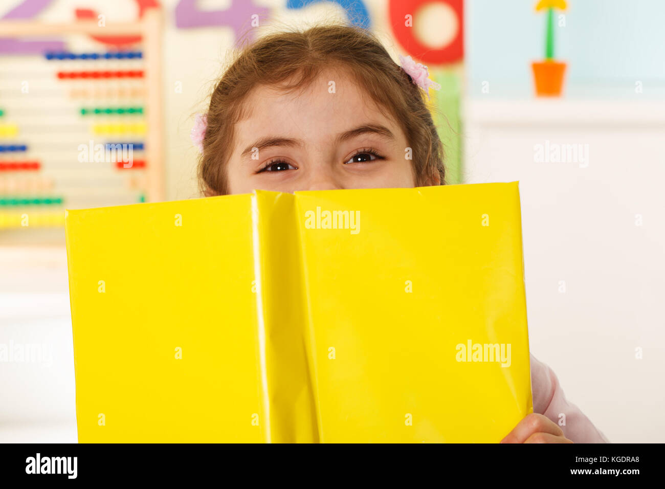Preschool girl with a books Stock Photo - Alamy
