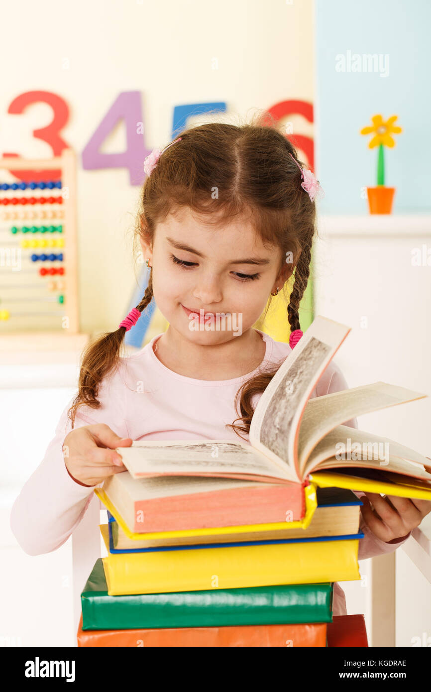 Preschool girl with a books Stock Photo - Alamy