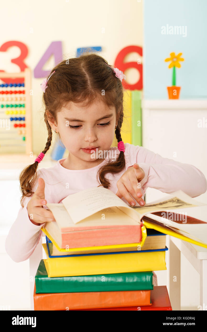Preschool girl with a books Stock Photo - Alamy