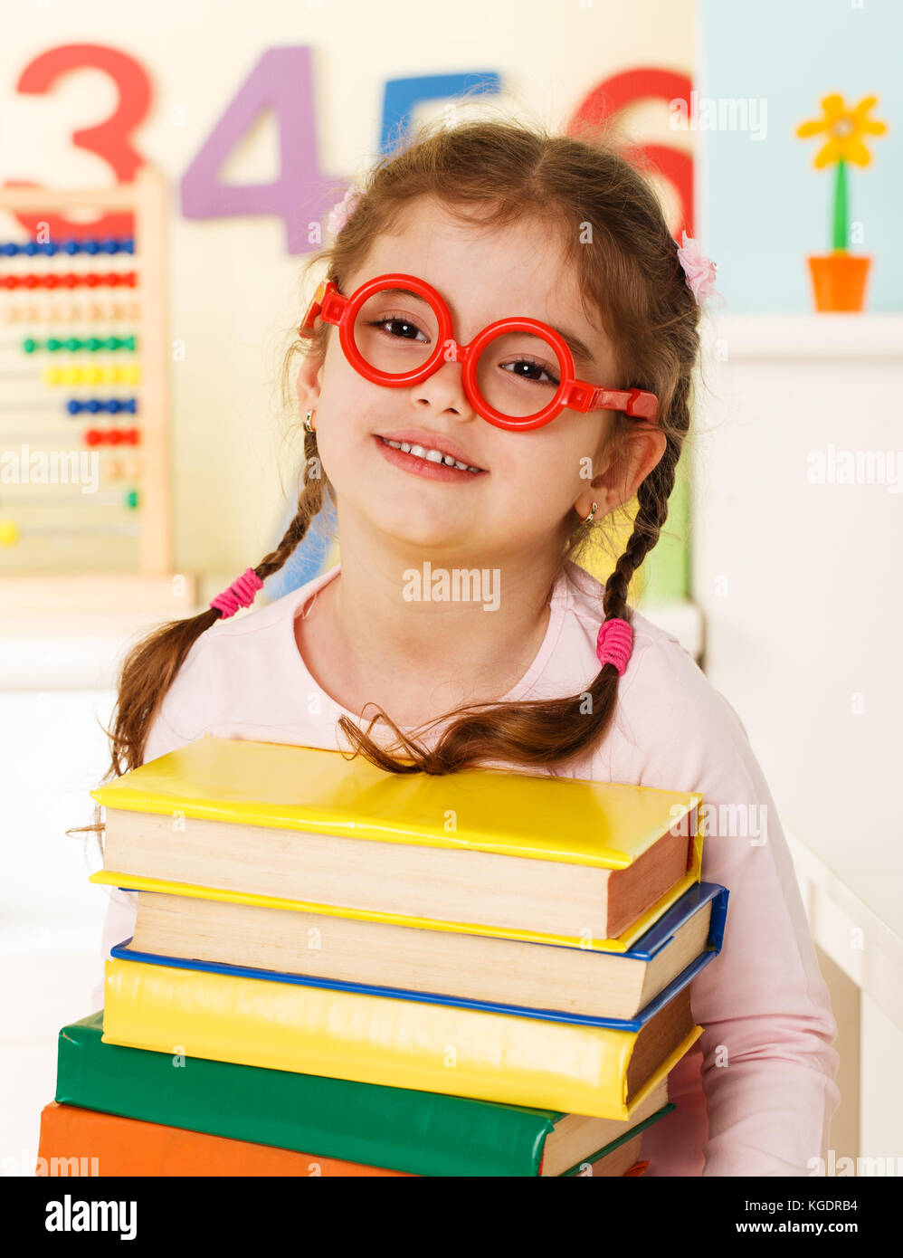 Preschool girl with a books Stock Photo - Alamy