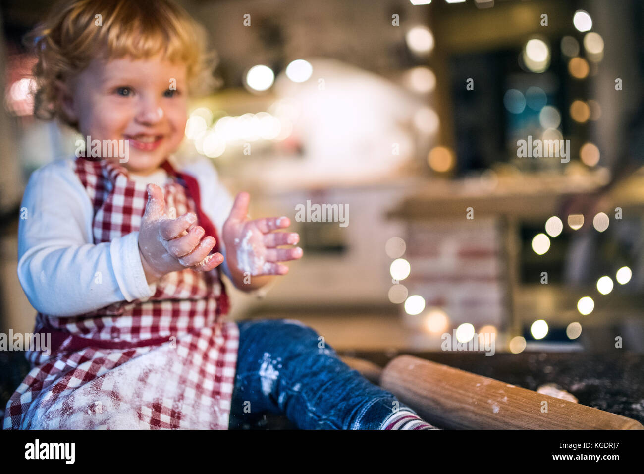 Toddler boy making gingerbread cookies at home. Stock Photo