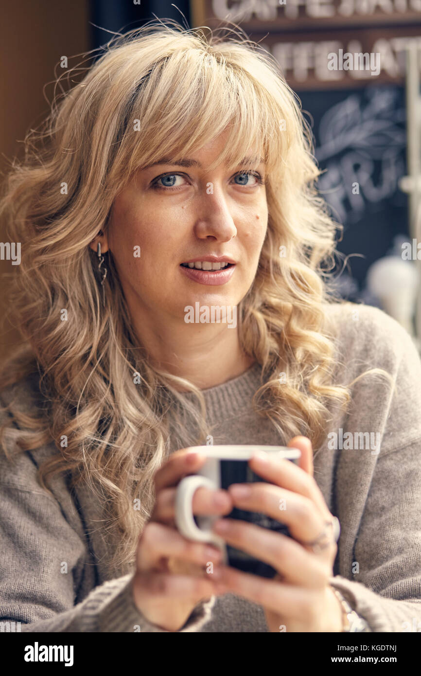 woman drinking coffee in the morning at restaurant Stock Photo Alamy