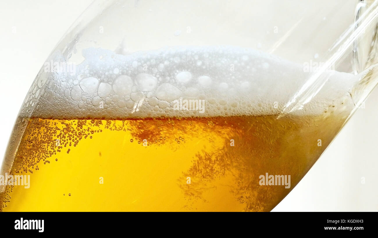 Pouring Beer into the Glass of Beer. Bottom View Stock Photo Alamy
