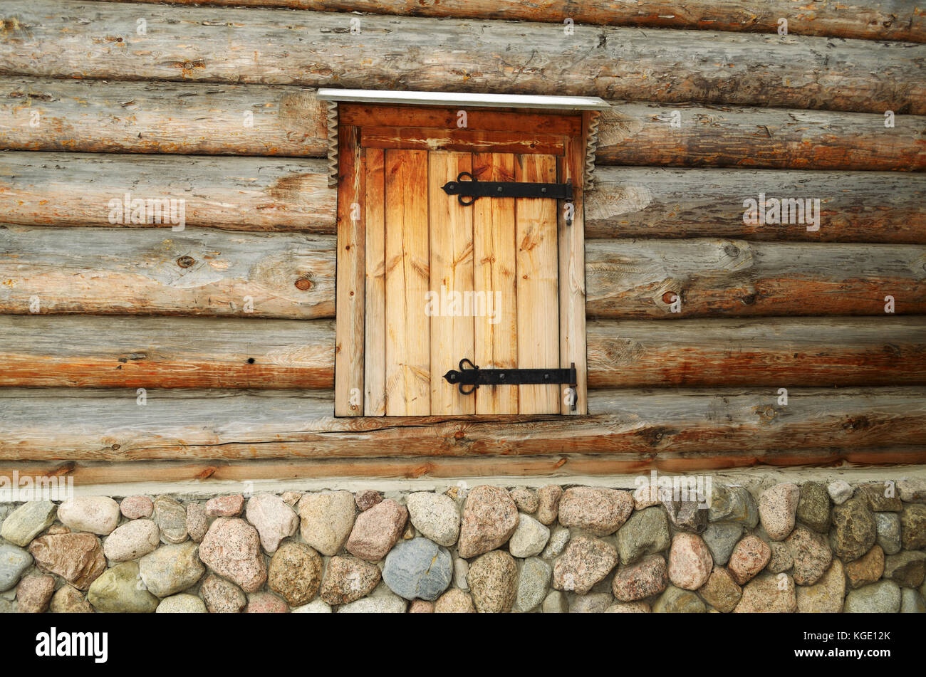 A wooden door in the wall of the log house. Stock Photo