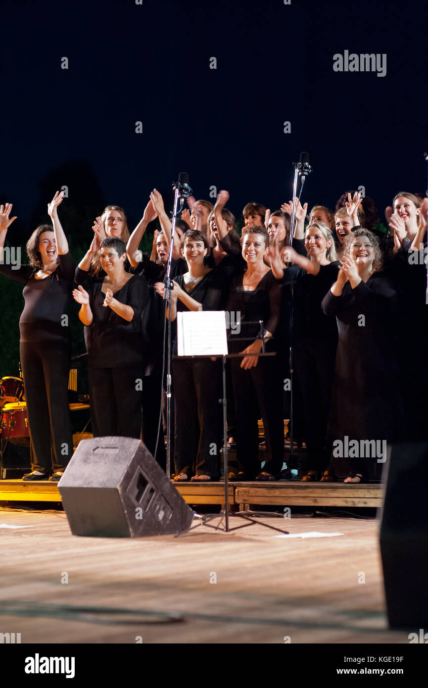 Gospel mixed group of people singing during a night concert. Christmas