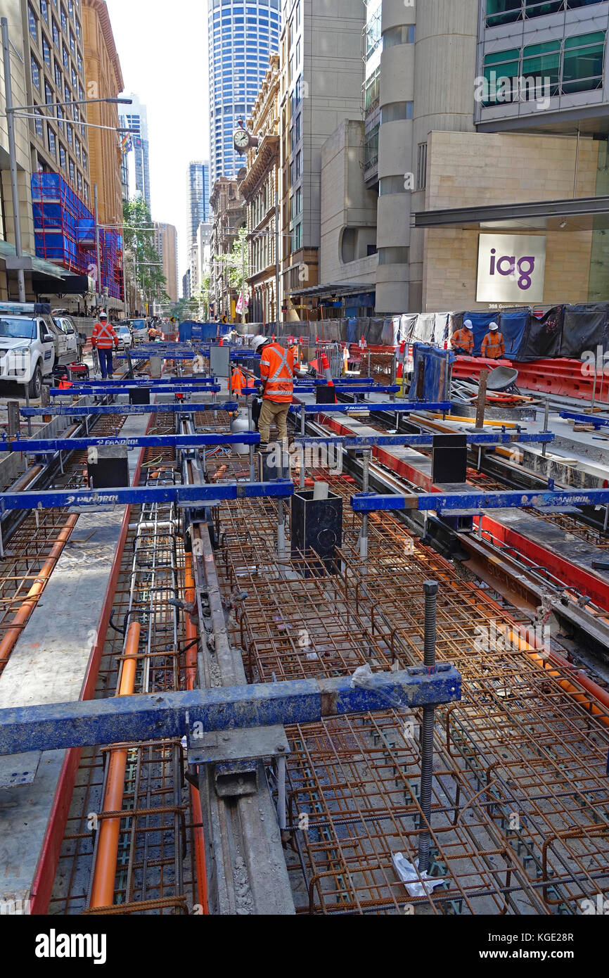 Construction work laying steel rail tracks along George Street in Sydney's CBD (central business district) for the 12km South East Light Rail route Stock Photo