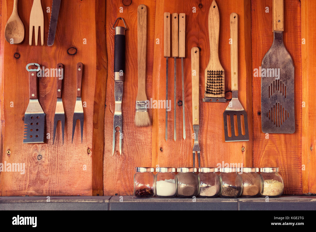 Grill, bbq area with tools hanging on the wall Stock Photo