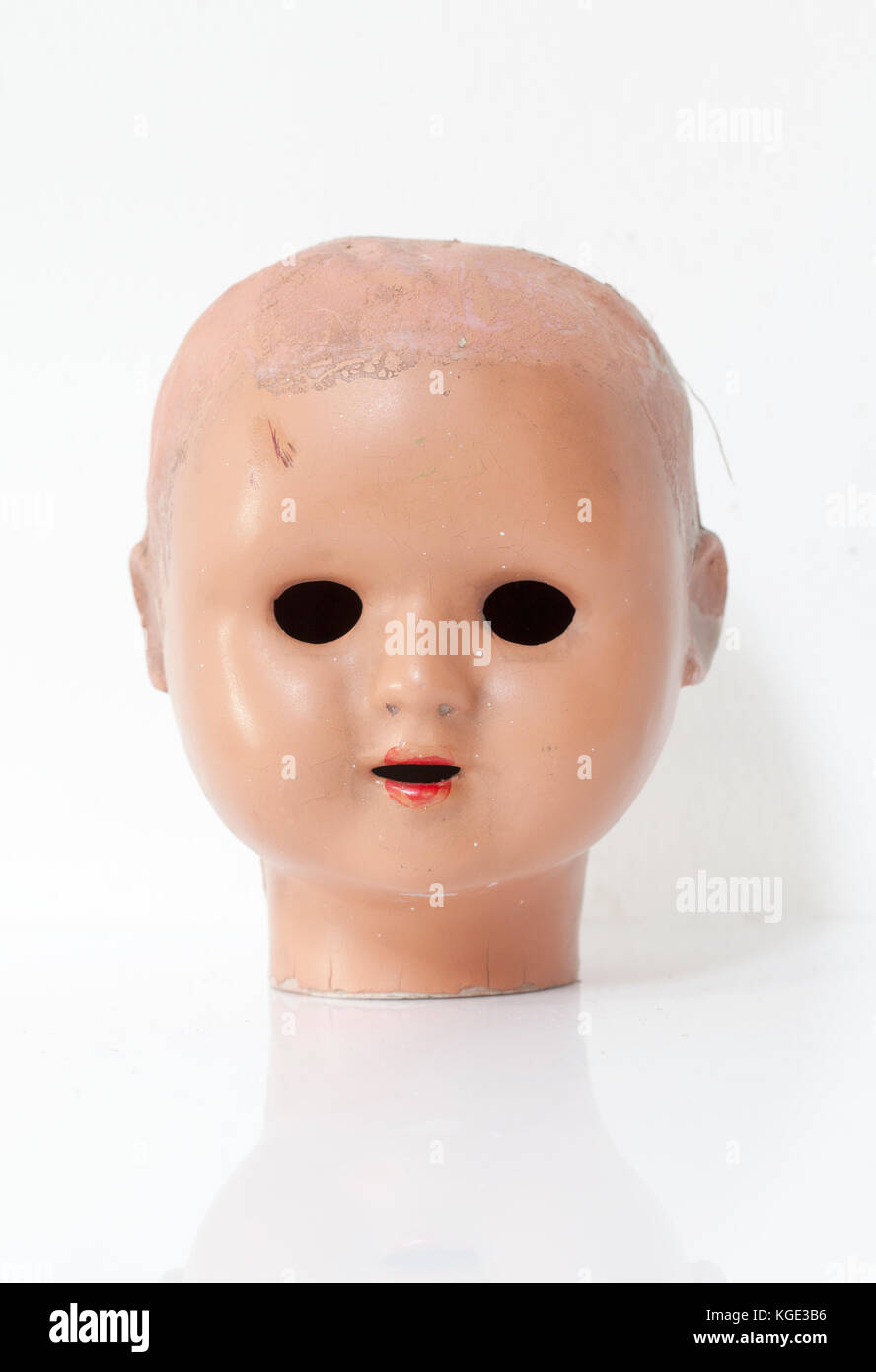 Creepy Baby Dolls Head against a white background Stock Photo