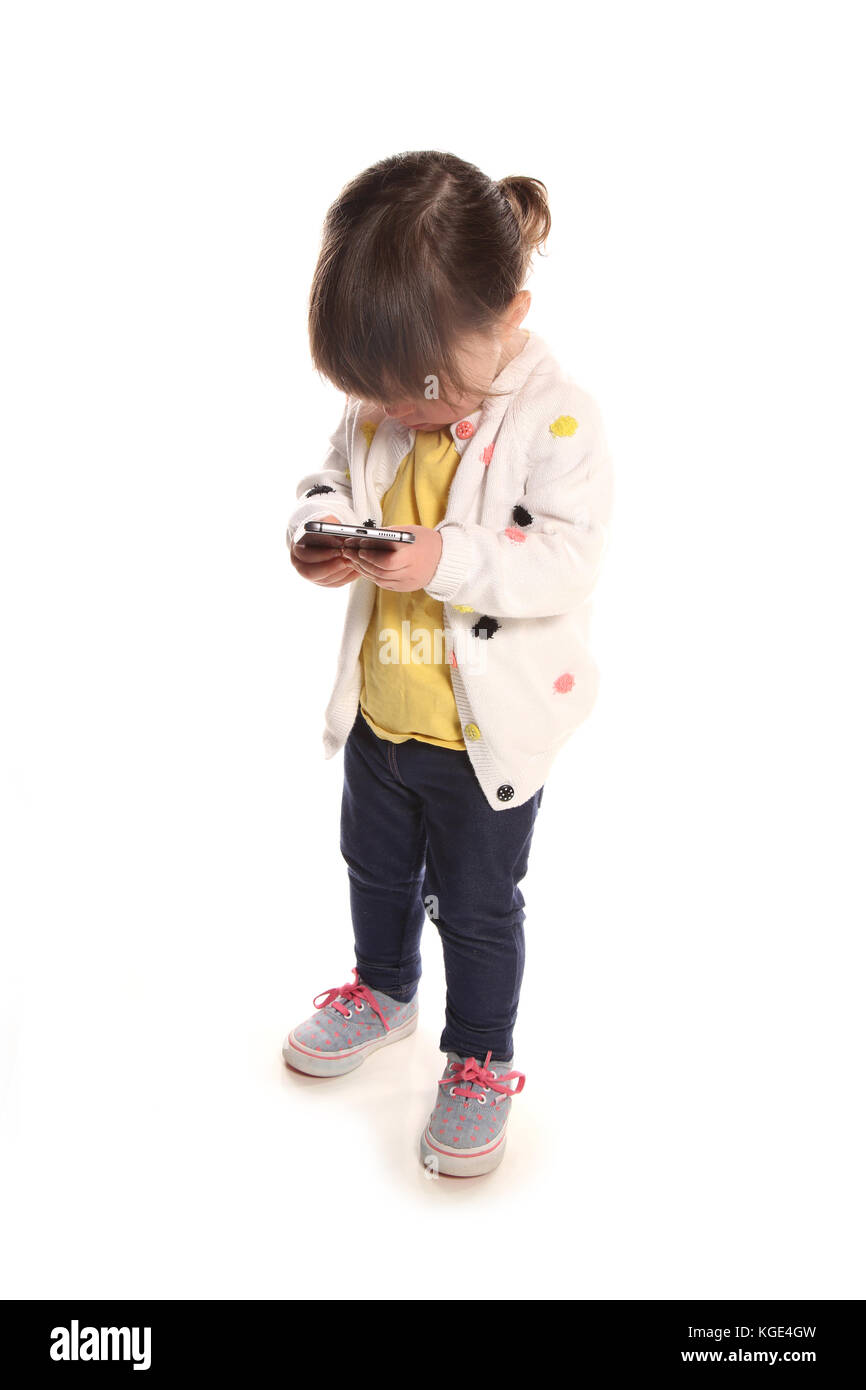 2 year old toddler play on mibile phone Stock Photo