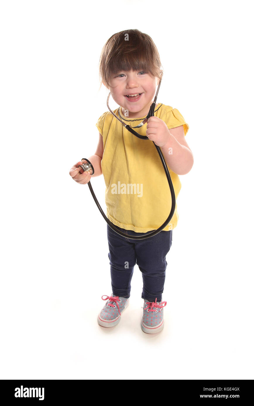 2 year old girl pretending to be a nurse Stock Photo