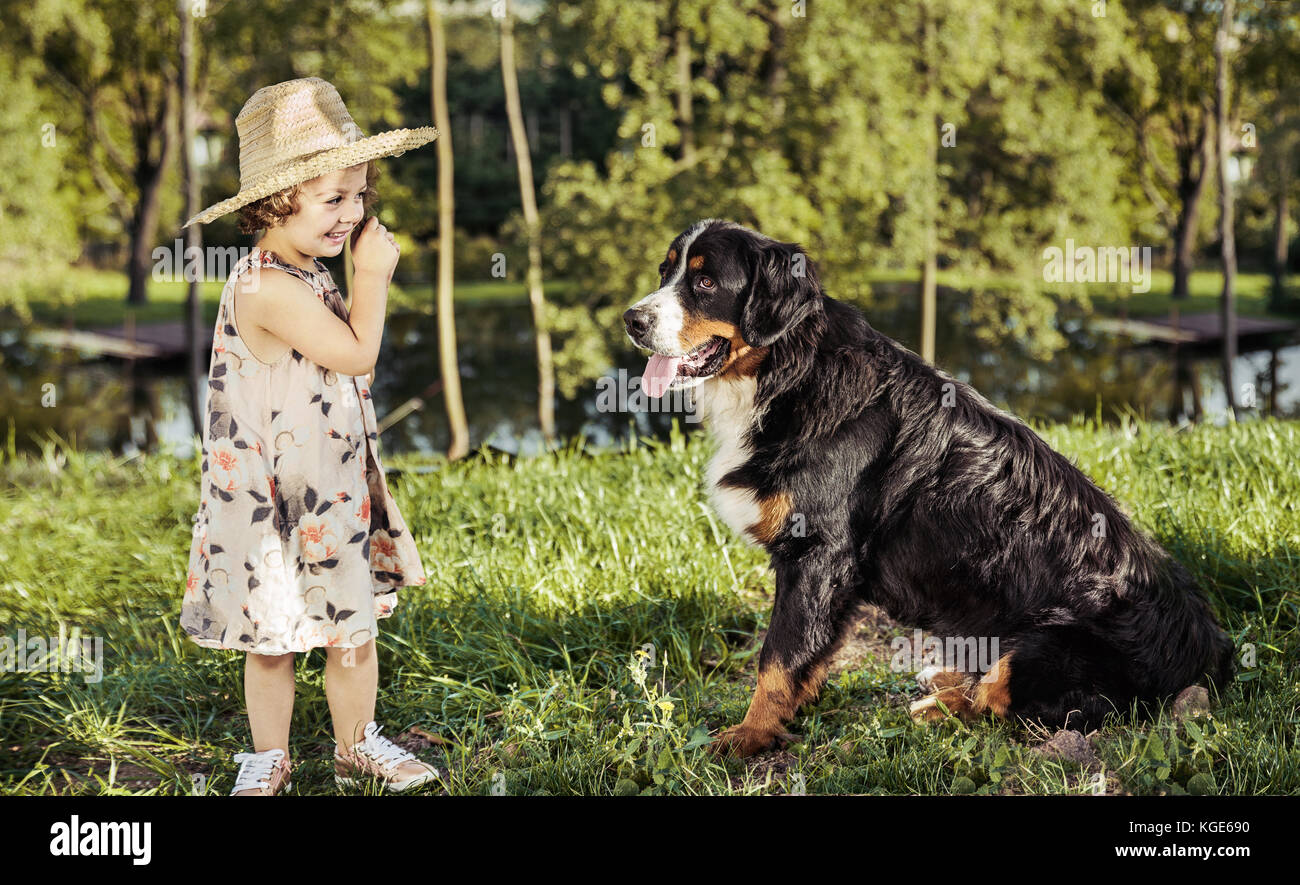 Portrait of a cute, little girl with a friendly dog Stock Photo - Alamy