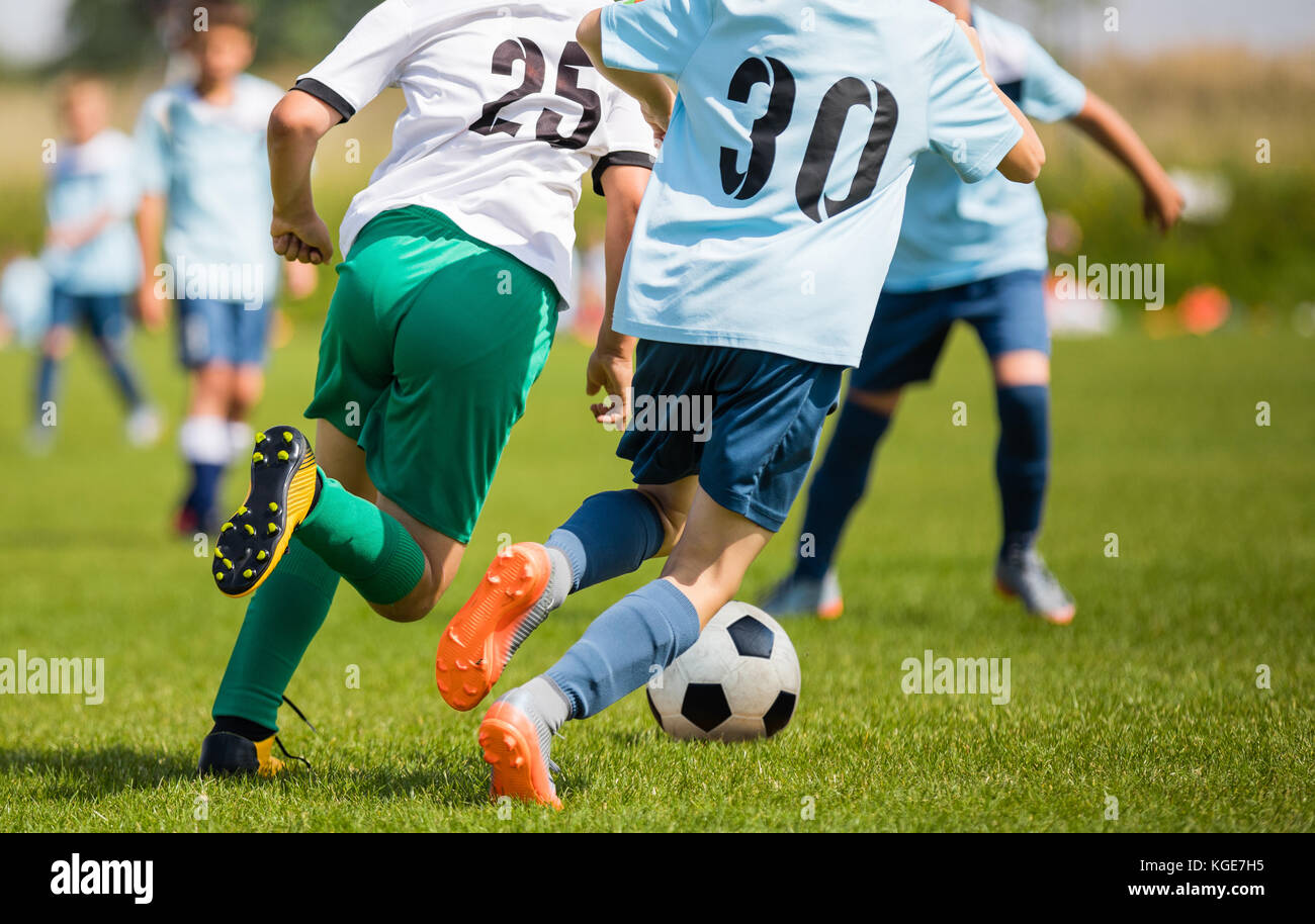 Boys Kicking Soccer Match on Grass. Youth Football Game. Children Sport