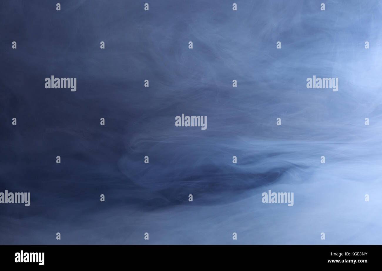 Abstract background of swirling blue smoke Stock Photo