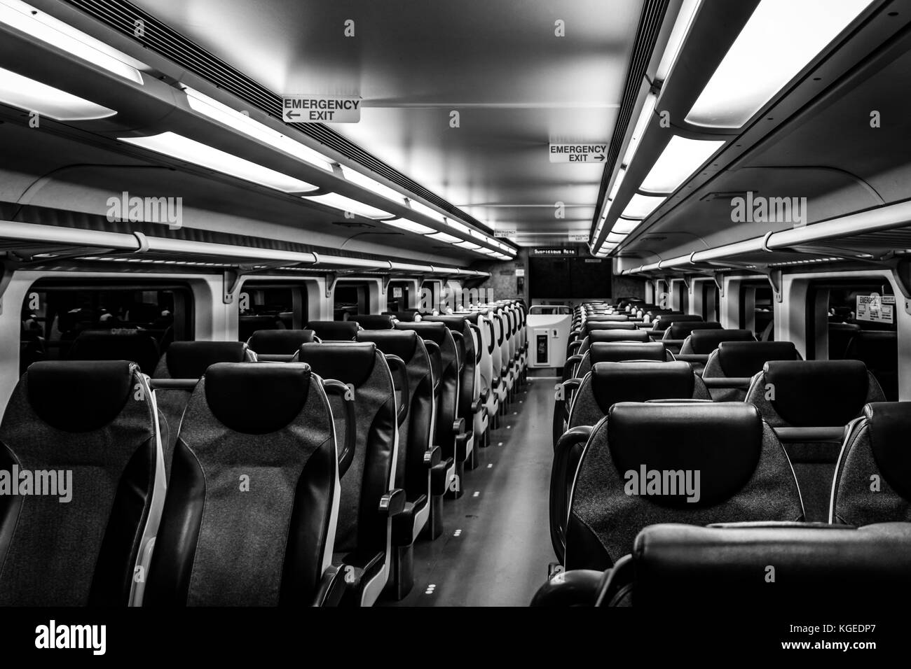 Dover, NJ USA - November 1, 2017:  New double-decker NJ Transit train at night with empty seats, black and white Stock Photo