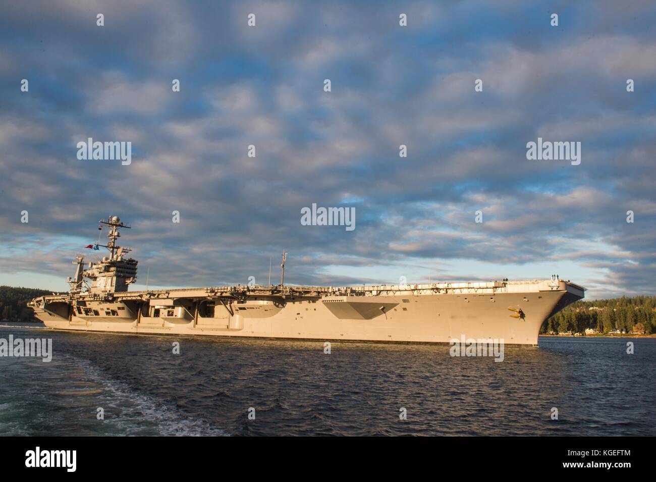 The Nimitz-class aircraft carrier USS John C. Stennis (CVN 74) transits Puget Sound. John C. Stennis is Stock Photo