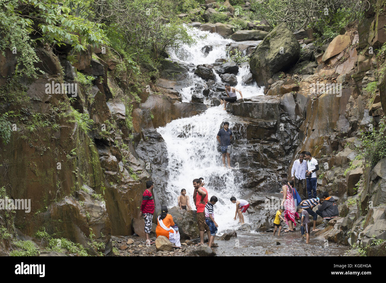 People enjoying with kids in a waterfall at Varandha Ghat, Pune, Maharashtra Stock Photo