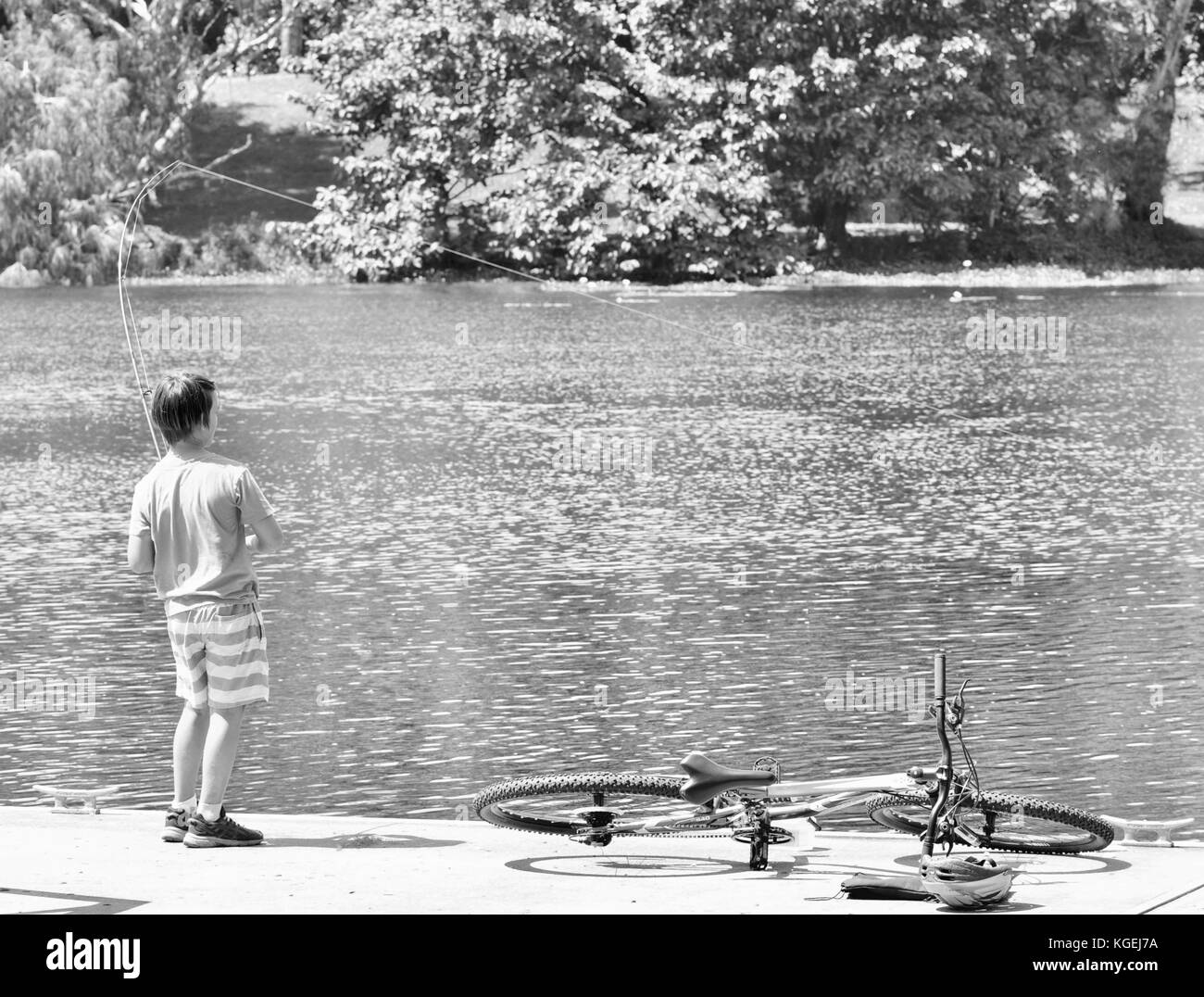 Several teenagers fishing off a pontoon in Ross River, Townsville, Queensland, Australia Stock