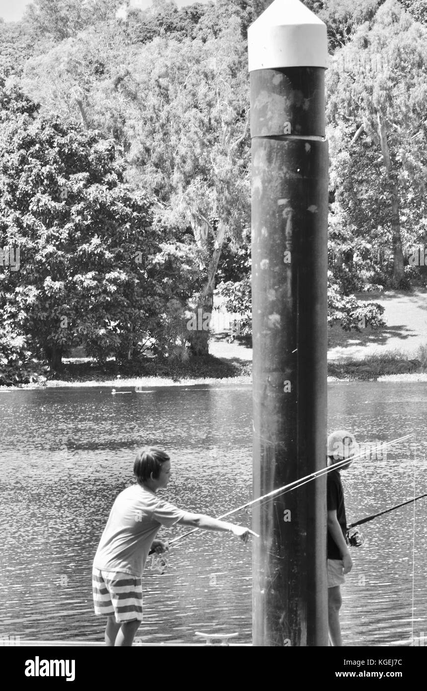 Several teenagers fishing off a pontoon in Ross River, Townsville, Queensland, Australia Stock