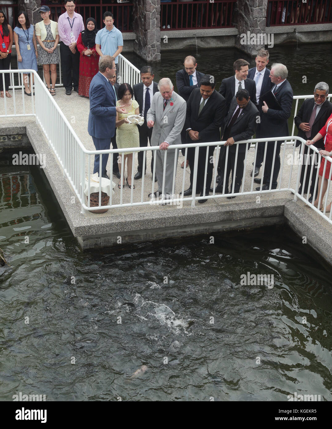 The Prince of Wales feeding fish during a visit to World Fish - an international, non-profit research organisation that harnesses the potential of fisheries and aquaculture to strengthen livelihoods and improve food and nutrition security - in Penang, Malaysia. Stock Photo