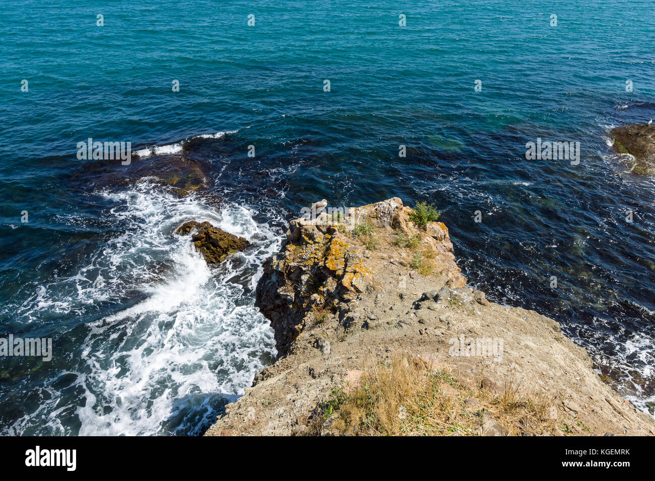 Blue sea, waves and rocky shore Stock Photo - Alamy