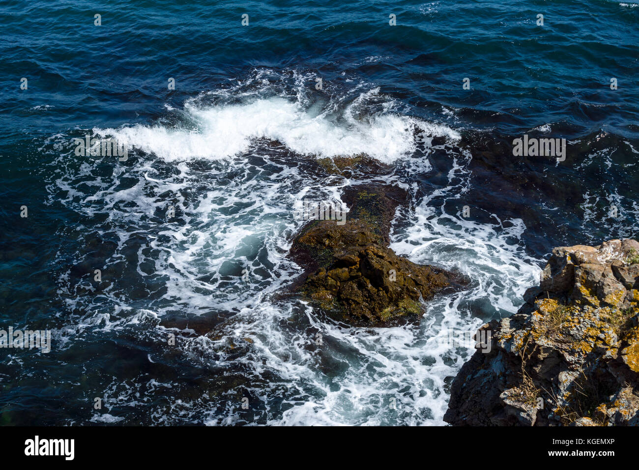 Blue sea, waves and rocky shore Stock Photo - Alamy