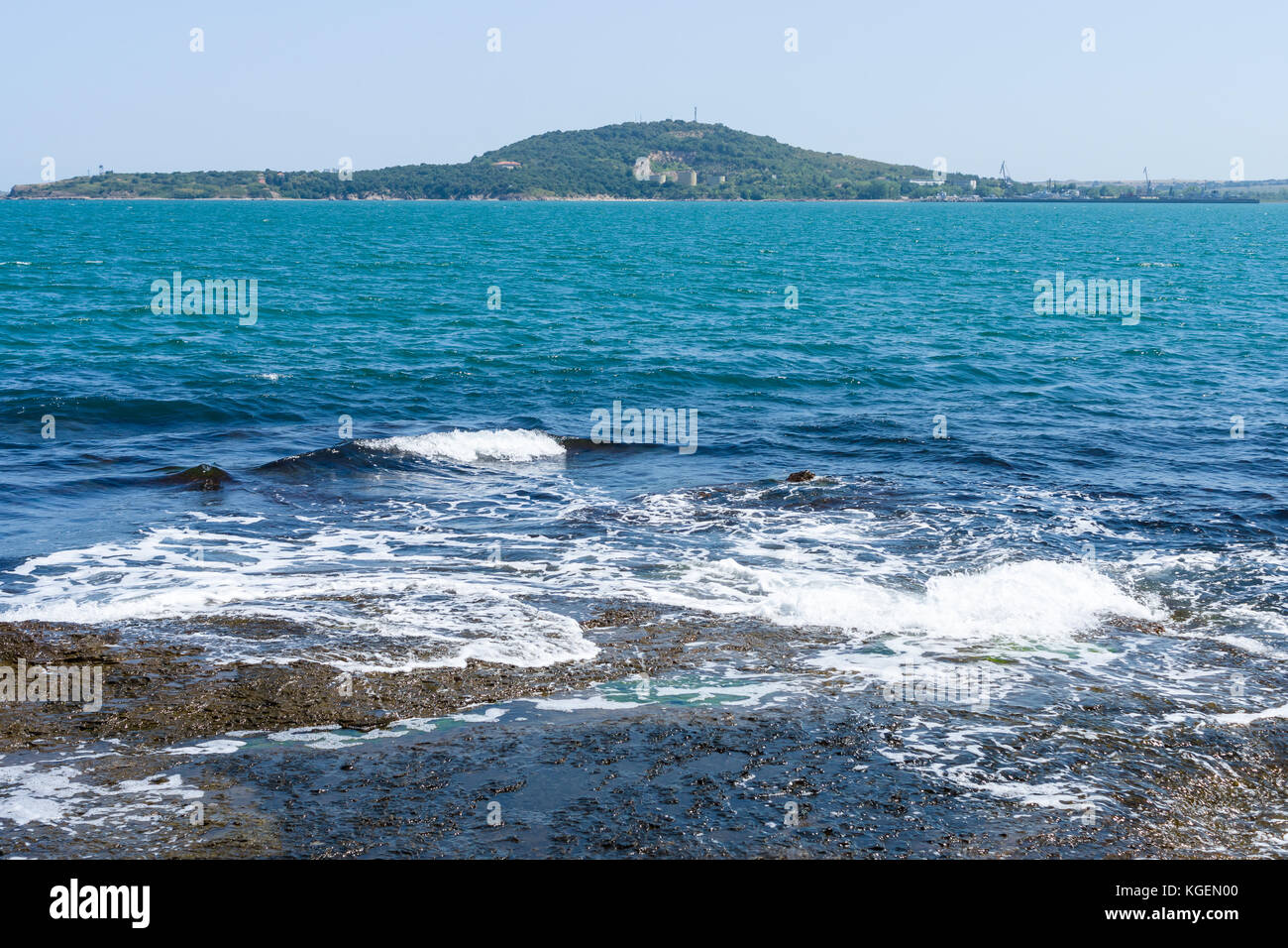 Blue sea, waves and rocky shore Stock Photo - Alamy