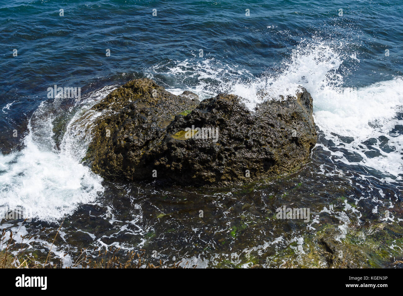 Blue sea, waves and rocky shore Stock Photo - Alamy