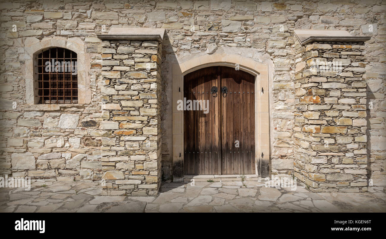 Stone house facade with old door and a small window Stock Photo - Alamy