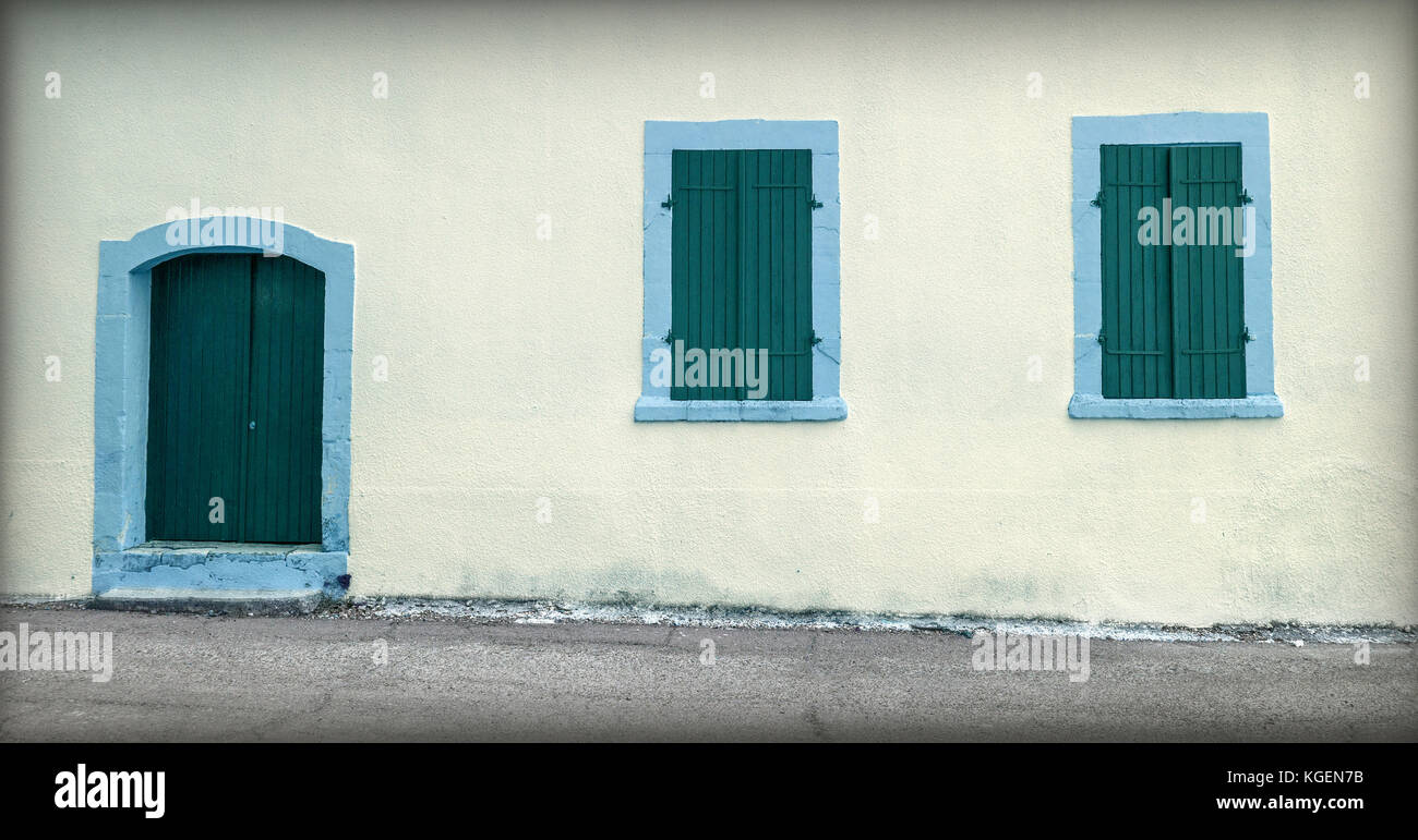 Stone house facade with old door and a small windows Stock Photo - Alamy