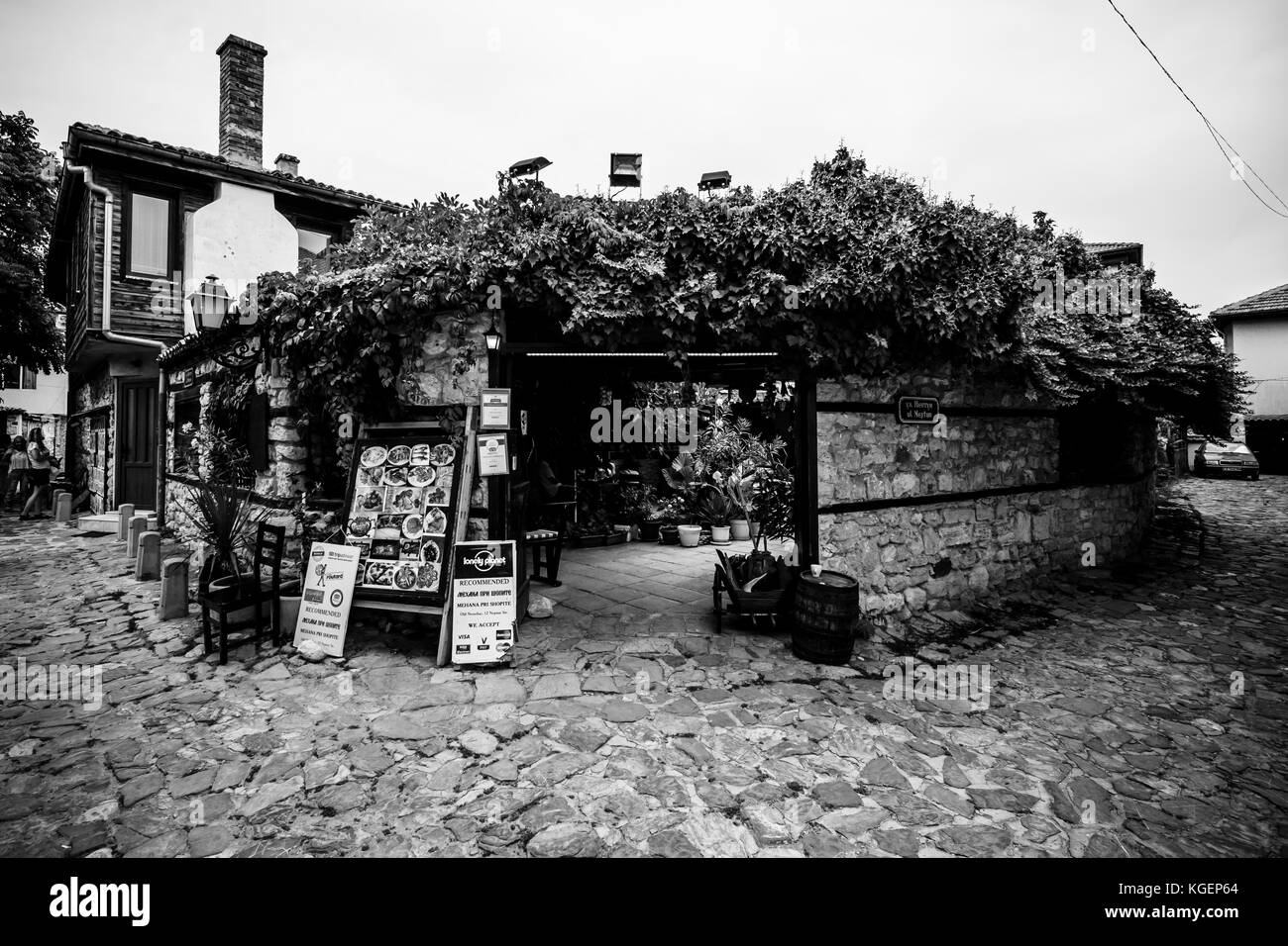 NESEBAR, BULGARIA - AUGUST 21, 2017: Typical restaurant in the UNESCO World Heritage town of Nesebar. Black and white. Nesebar is an ancient city and Stock Photo