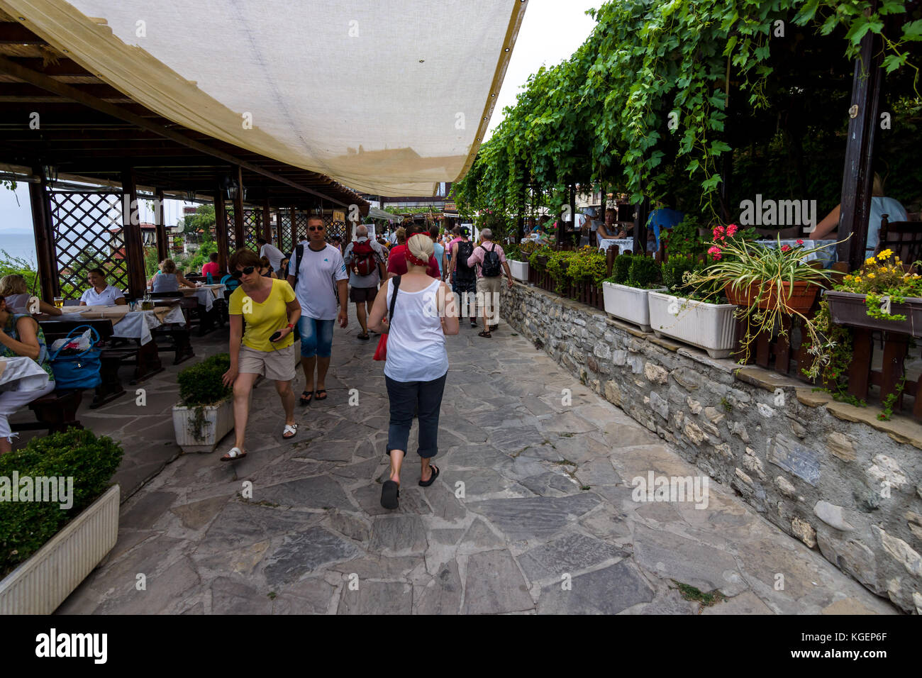 Street and tourists, typical restaurants and cafes in the UNESCO World Heritage town of Nesebar. Bulgaria. Stock Photo