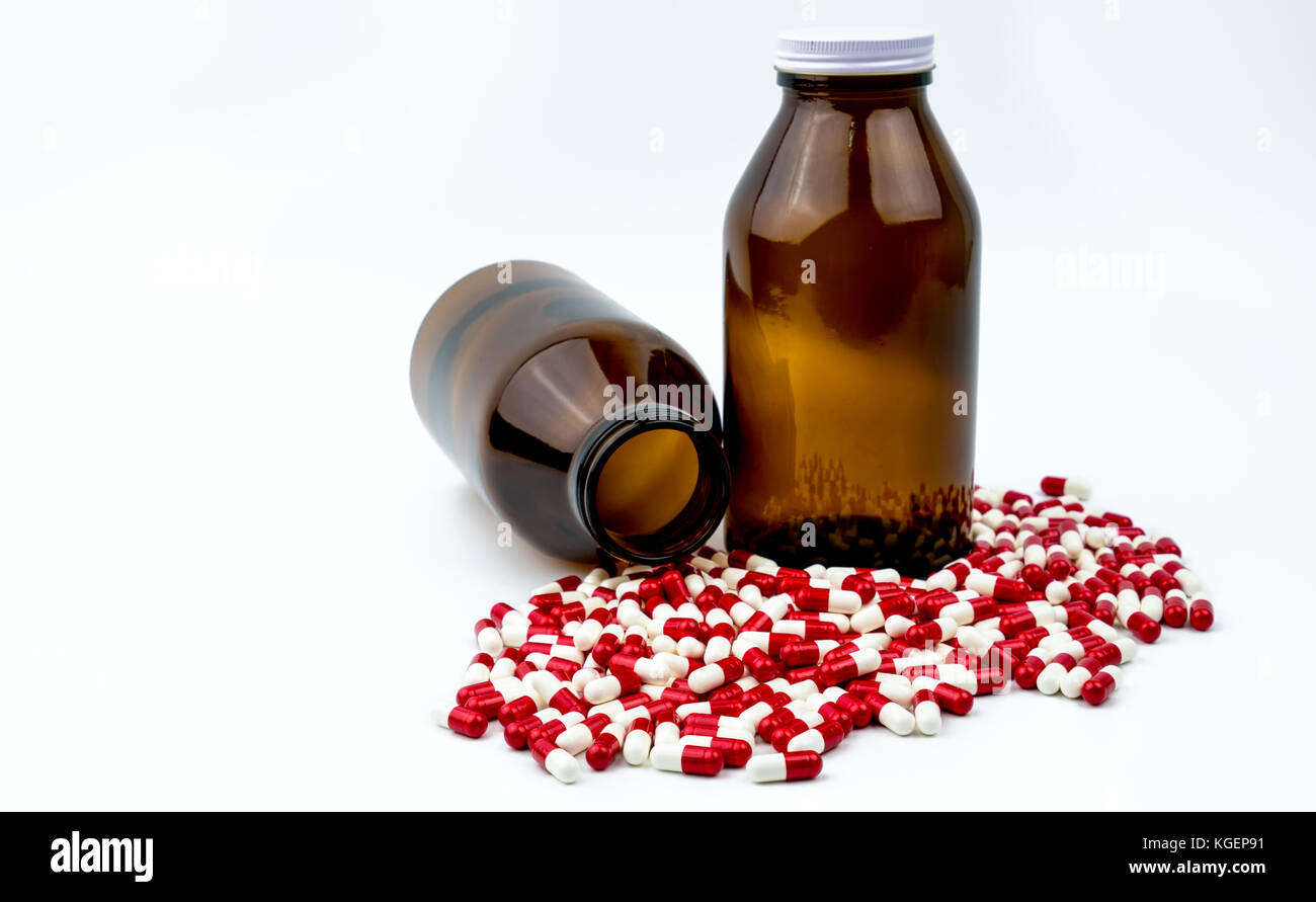 Colorful of antibiotic capsules pills with two amber glass bottles