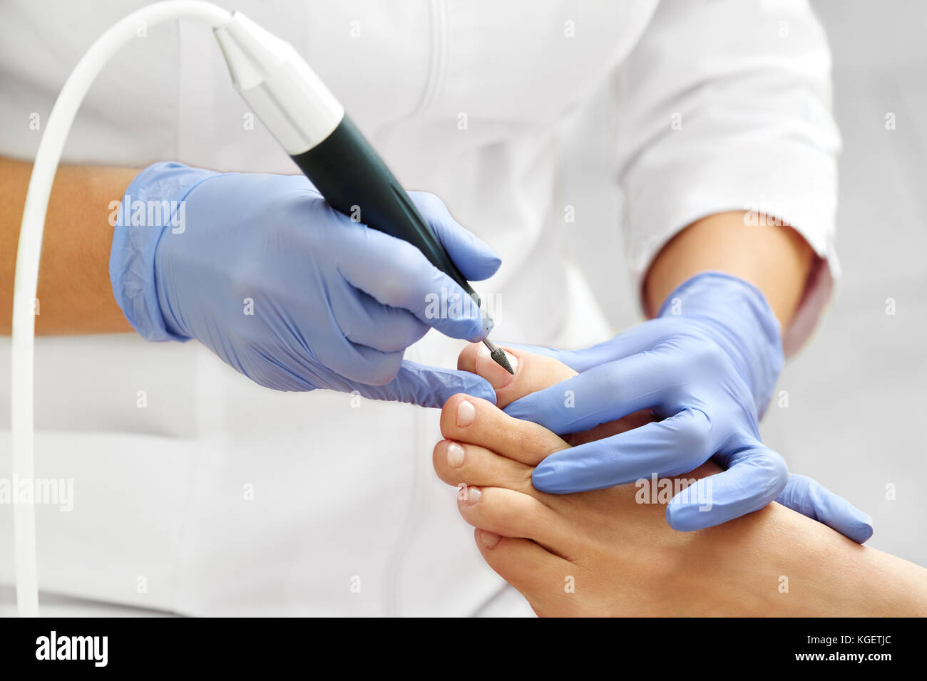 Professional hardware pedicure using electric machine.Patient on medical pedicure procedure