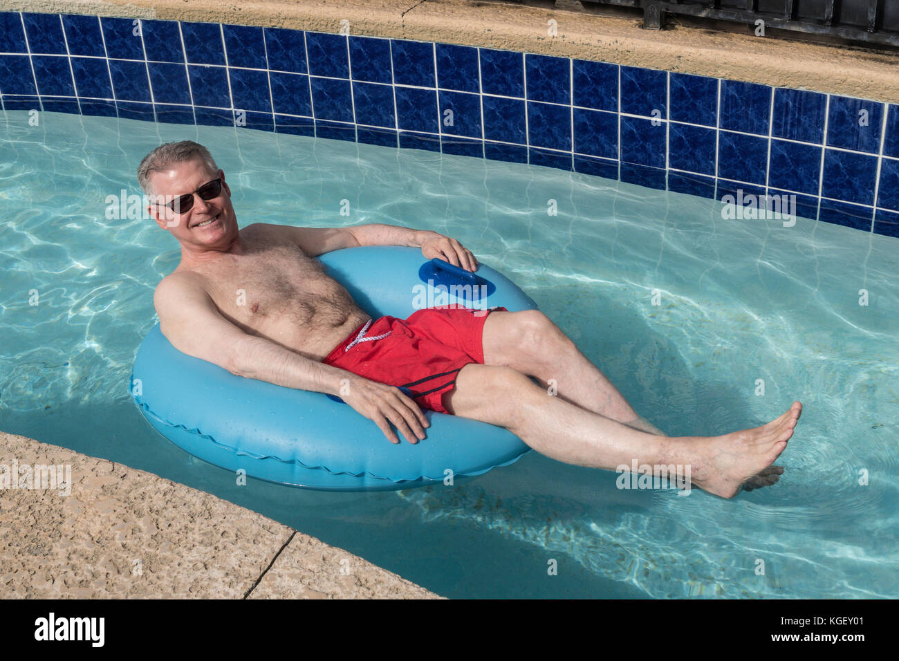 Senior Man Enjoying Resort Swimming Pool, USA Stock Photo