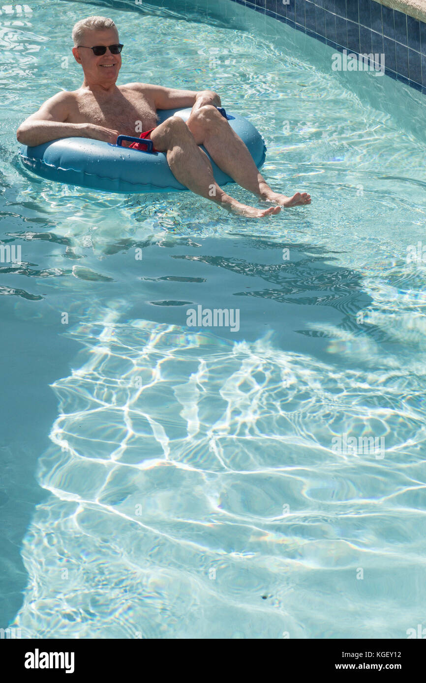 Senior Man Enjoying Resort Swimming Pool, USA Stock Photo