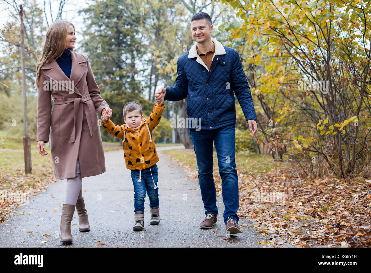 Mom Dad And A Little Boy Walk In The Park Stock Photo 165056349