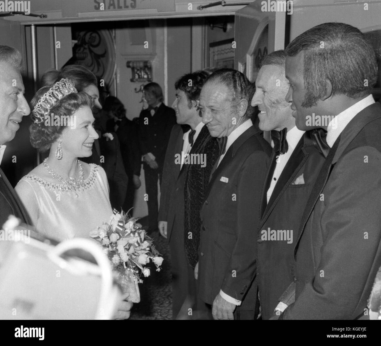 Queen Elizabeth II meeting British entertainer Bruce Forsyth at the Royal Variety Performance, London Palladium. Next to Forsyth are comedian Sid James, left, and singer Lovelace Watkins. Stock Photo