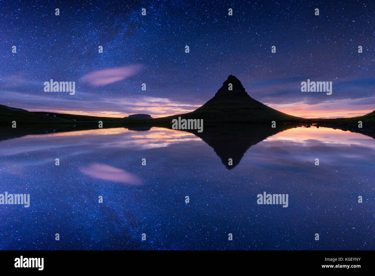 Starry sky on Kirkjufellsfoss waterfall. Stock Photo