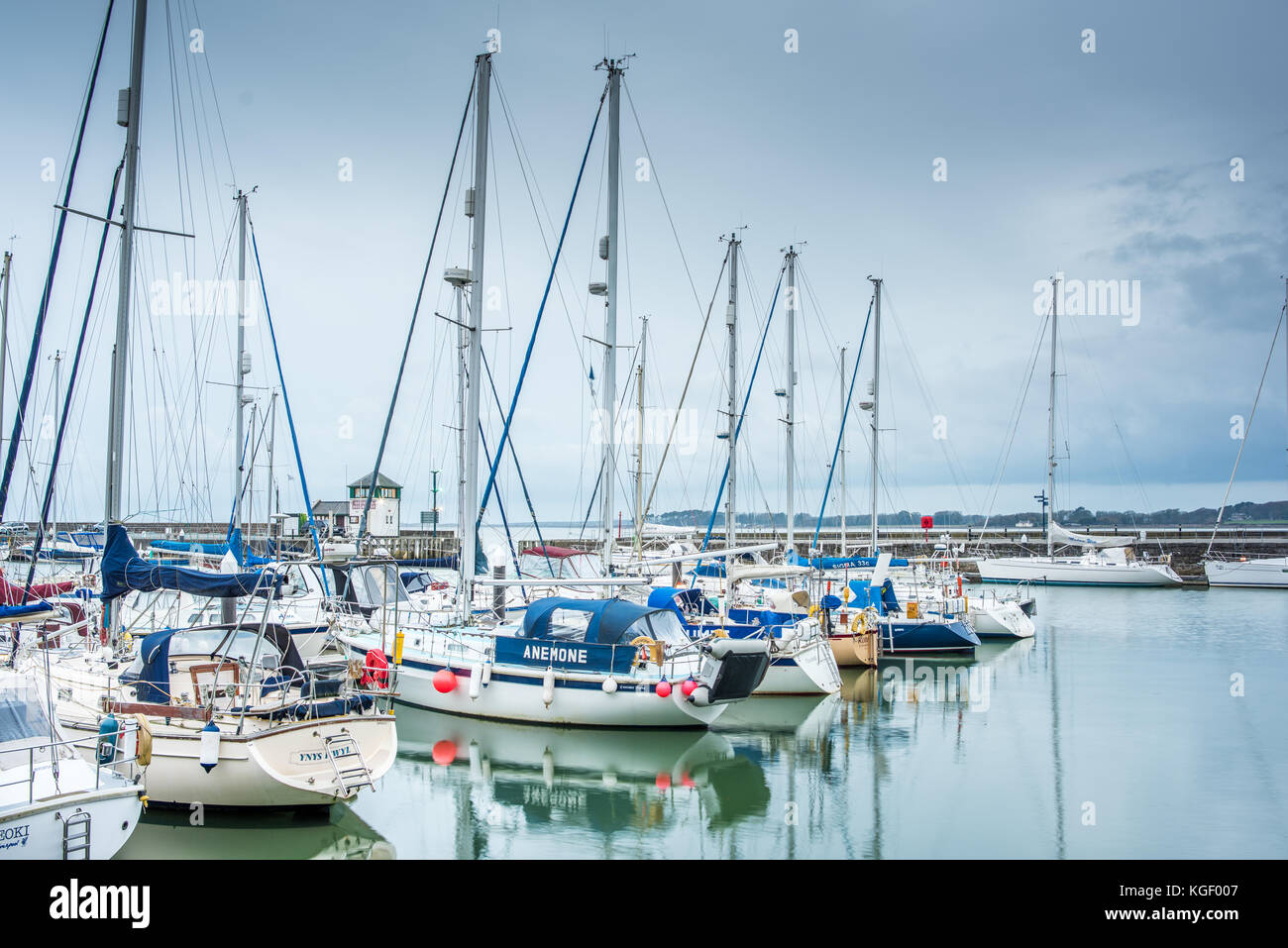 Luxury motor and sailing boats moored for winter in the marina harbour