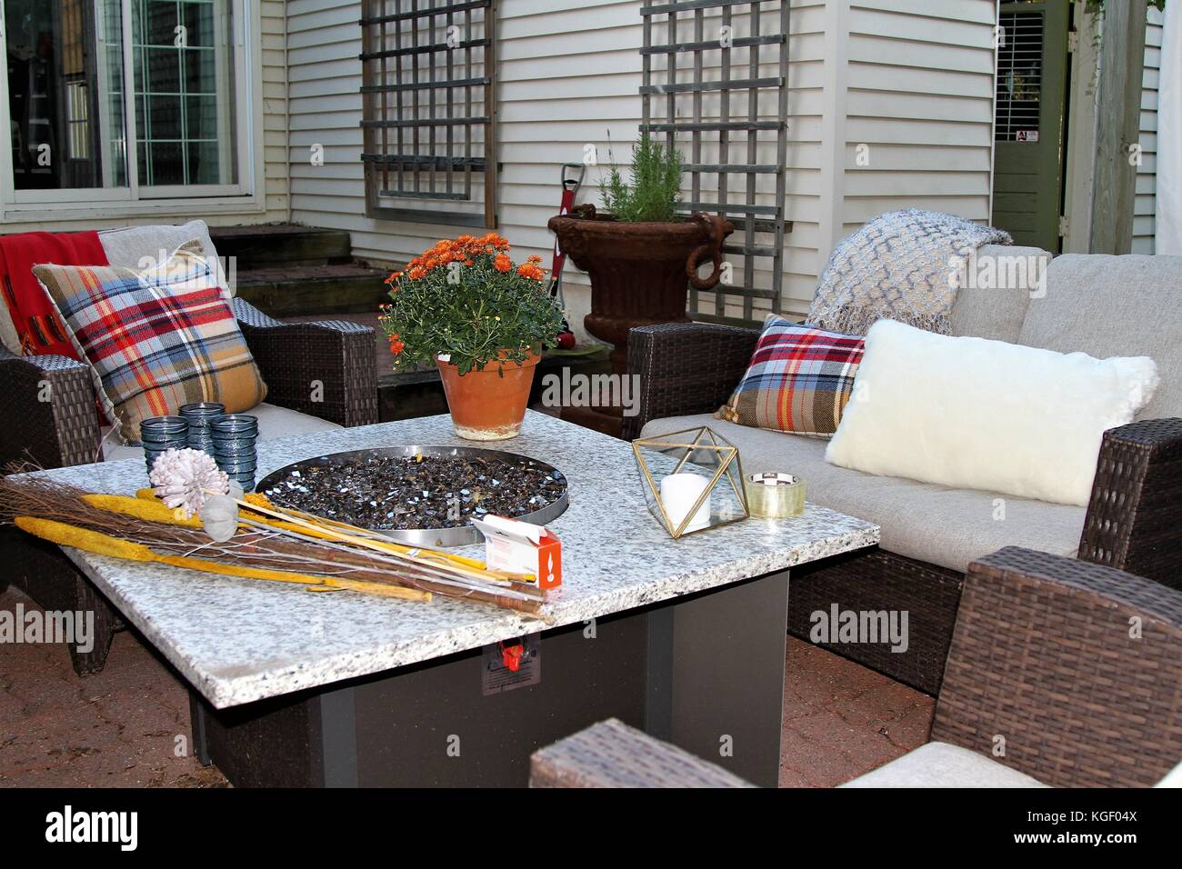 Outdoor Seating Arrangement Around A Gas Fire Pit Table In The