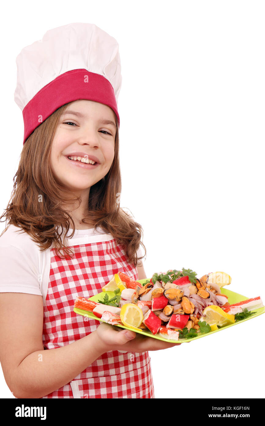happy little girl cook with seafood on plate Stock Photo