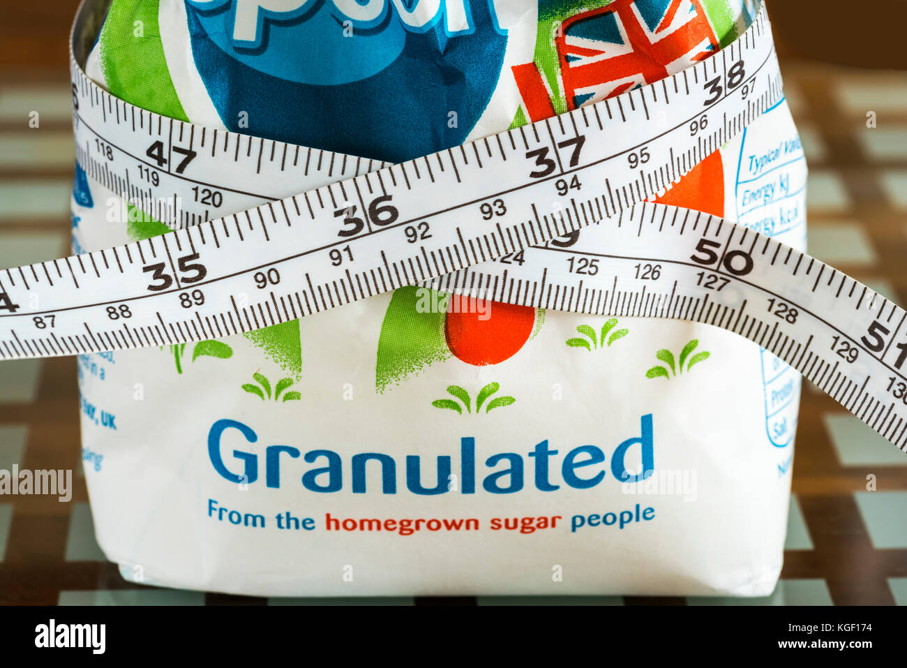 Bag of sugar with tape measure, too much sugar, obesity Stock Photo