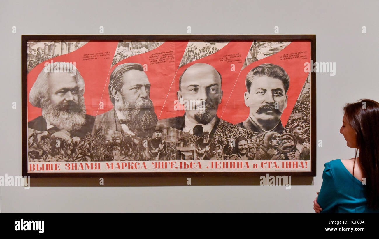 London, UK. 7th Nov, 2017. A staff member views 'Under the Banner of Marx, Engels, Lenin and Stalin!', 1933, by Gustav Klutsis, at a preview of 'Red Star Over Russia: A Revolution in Visual Culture 1905-55' at Tate Modern. The exhibition marks the centenary of the October Revolution and presents the visual history of Russia and the Soviet Union with works drawn primarily from the collection of the late graphic designer David King. Credit: Stephen Chung/Alamy Live News Stock Photo