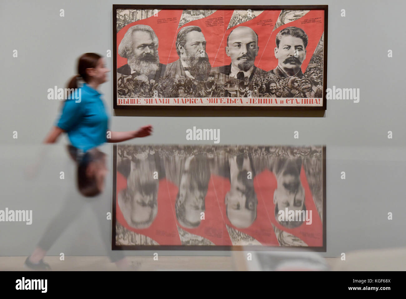 London, UK. 7th Nov, 2017. A student from Thomas Tallis School, Kidbrooke, south London, walks by 'Under the Banner of Marx, Engels, Lenin and Stalin!', 1933, by Gustav Klutsis, at a preview of 'Red Star Over Russia: A Revolution in Visual Culture 1905-55' at Tate Modern. The exhibition marks the centenary of the October Revolution and presents the visual history of Russia and the Soviet Union with works drawn primarily from the collection of the late graphic designer David King. Credit: Stephen Chung/Alamy Live News Stock Photo