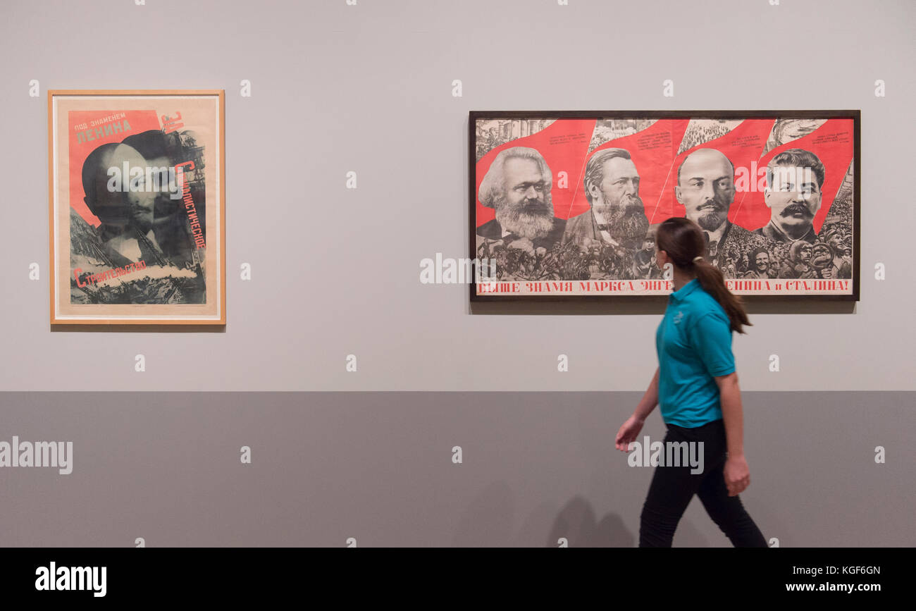 Tate Modern, London, UK. 7th Nov, 2017. Red Star Over Russia: A Revolution in Visual Culture 1905-55. Featuring over 250 posters, paintings and photographs, many on public display for the first time, the exhibition shows how life and art were transformed during a defining period in modern world history. The exhibition runs from 8 November 2017 - 18 February 2018. A pupil from Thomas Tallis School in Kidbrooke (supplied by gallery) passes a poster titled Under the Banner of Marx, Engels, Lenin and Stalin! Credit: Malcolm Park/Alamy Live News. Stock Photo