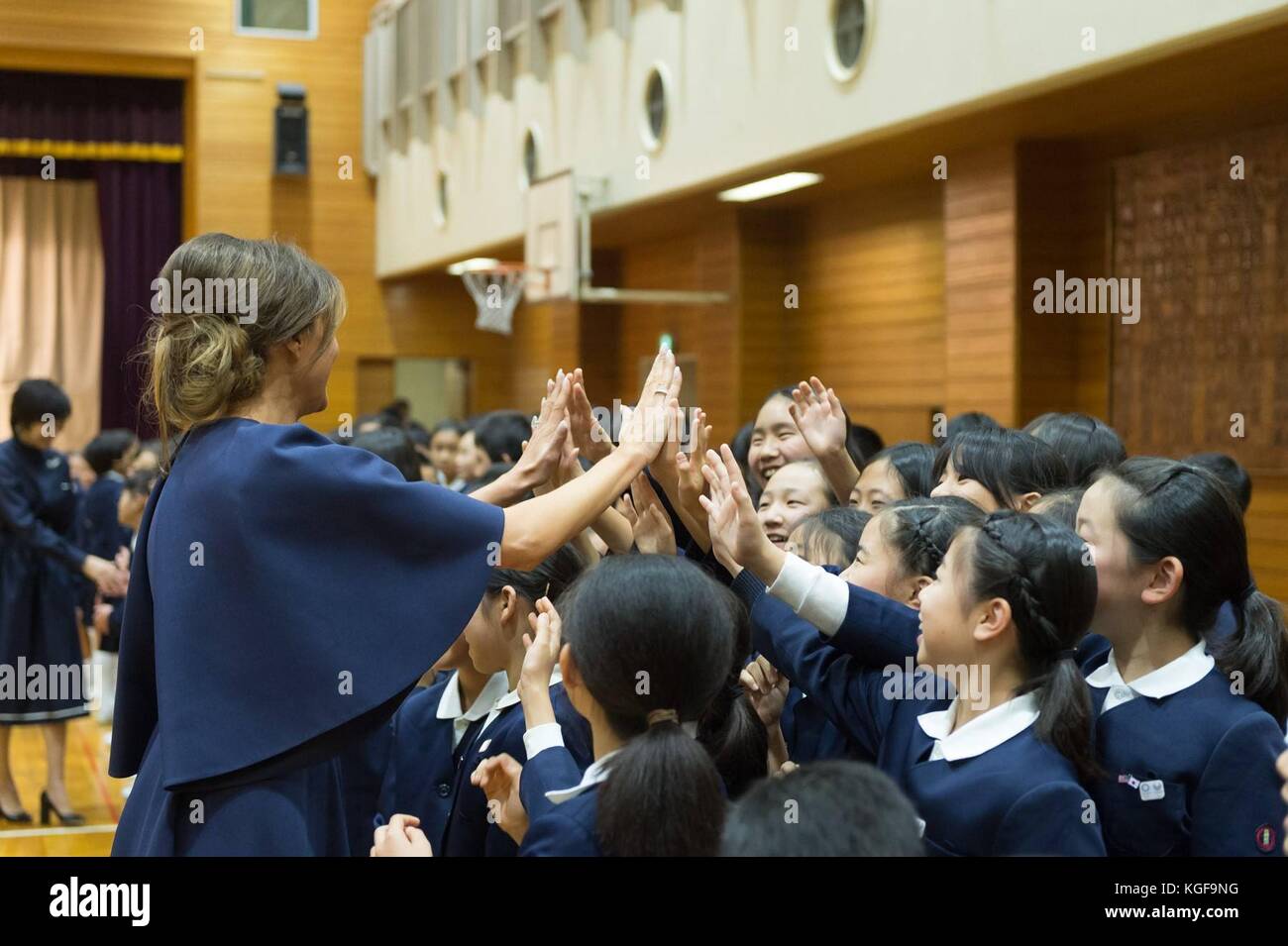 U.S first lady Melania Trump, center, high fives children during a visit to the 4th grade calligraphy class at Kyobashi Tsukiji Elementary School November 6, 2017 in Tokyo, Japan. Trump is on a three-day visit to Japan, the first stop of a 13-day swing through Asia. Stock Photo