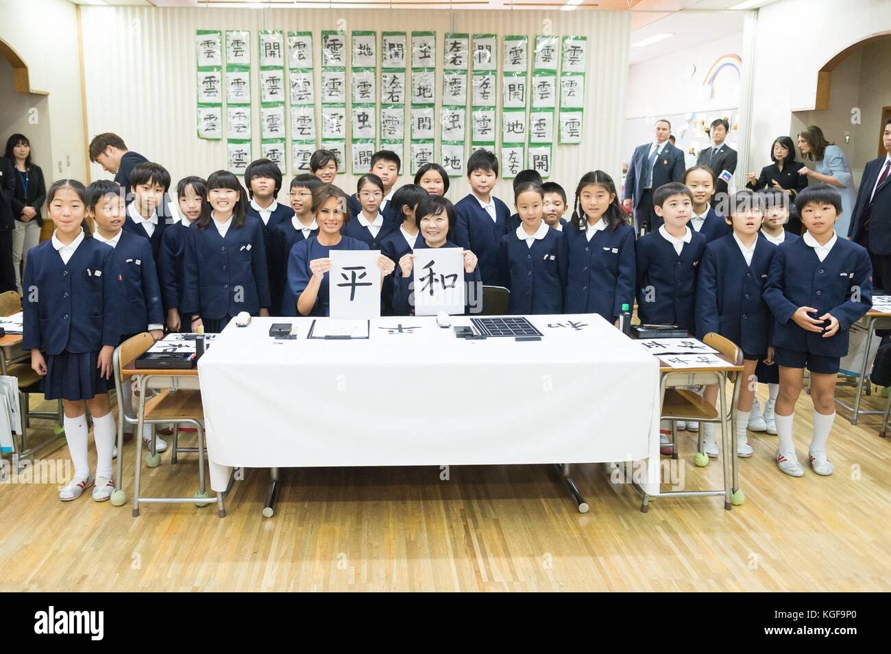 U.S first lady Melania Trump, left, and Akie Abe, right, wife of Japanese Prime Minister Shinzo Abe show off their work during a visit to the 4th grade calligraphy class at Kyobashi Tsukiji Elementary School November 6, 2017 in Tokyo, Japan. Trump is on a three-day visit to Japan, the first stop of a 13-day swing through Asia. Stock Photo